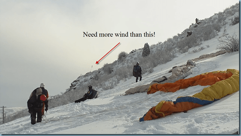 PGs on snow and limp windsock in background